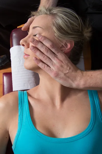 Quiropráctico ajustando los músculos del cuello paciente joven — Foto de Stock