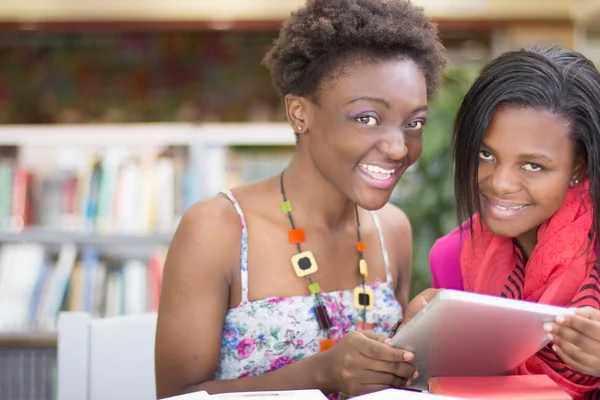 African Students doing research at the library — Stock Photo, Image