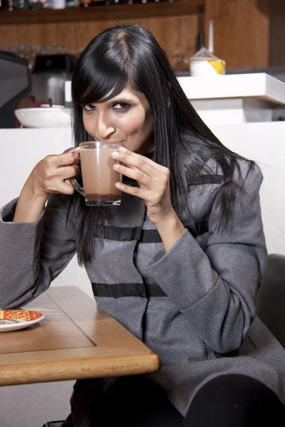 Young relaxed indian woman enjoying her coffee — Stock Photo, Image