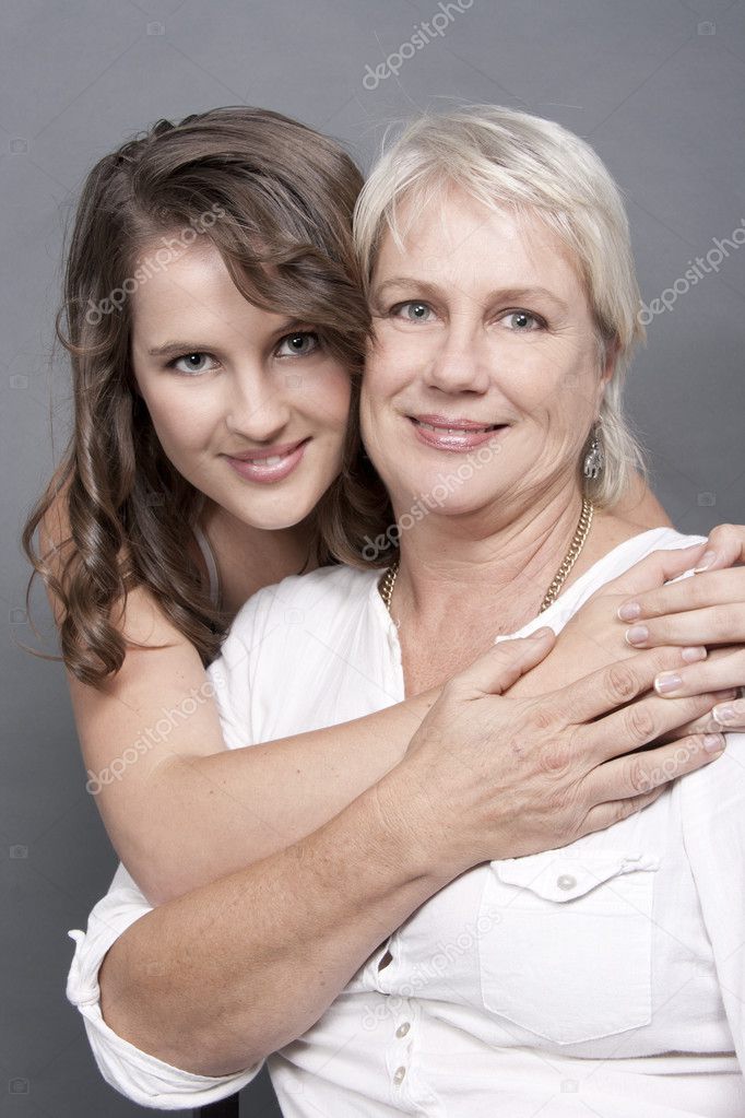 Beautiful Adult Daughter holding hug her Mother