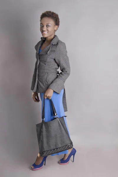 Beautiful Black Woman walking holding her handbag — Stock Photo, Image