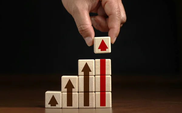 Ladder career path for business growth success process concept.Hand arranging wood block stacking as step stair with arrow up.