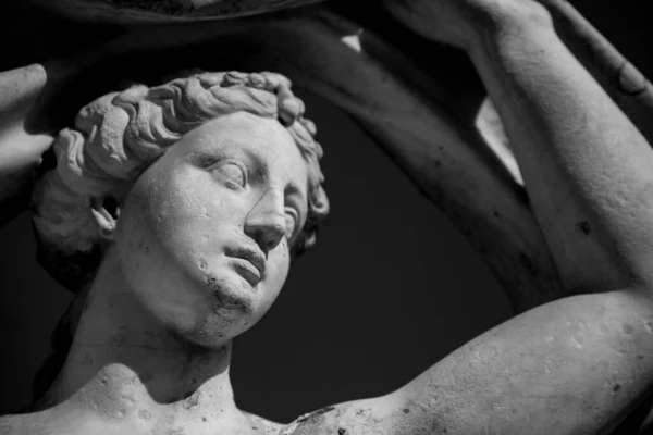 the statue is white. portrait of a woman. sculpture of a woman. close-up