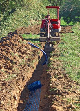 Excavation of a trench by a digger. 