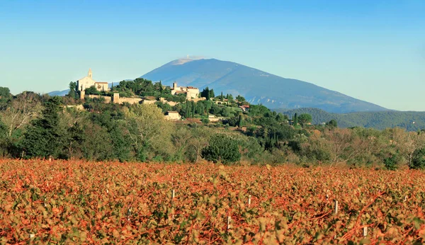 The village of Cairanne surrounded by vineyards, against the backdrop of Mont Ventoux.