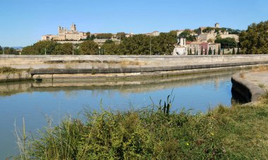 The Saint-Nazaire cathedral in Bziers reflecting in the Orb river. 