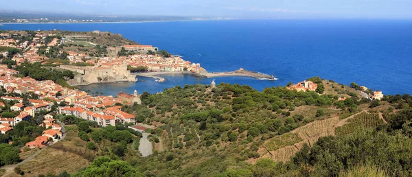 Small boats on the sand of the curved beach of Collioure.