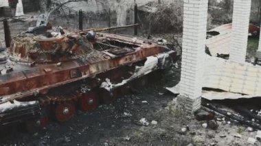 Ukrayna 'da savaş, özel bir evin bahçesinde etkisiz hale getirilmiş ve yanmış zırhlı araç, hava fotoğrafçılığı.