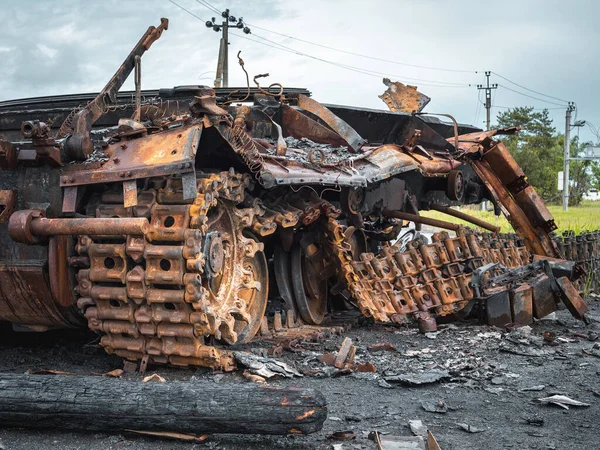 The war in Ukraine, an exploded tank, an exploded tank without a tower stands on the outskirts of the village