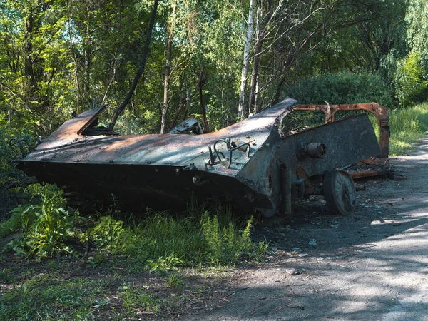The war in Ukraine, the destroyed BMP, the BMP torn apart by the explosion stands near the road, front view.