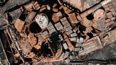 War in Ukraine, destroyed tank, drone slowly takes off over the destroyed tank, aerial photography