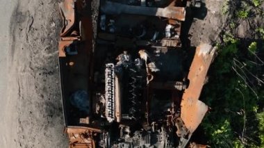  War in Ukraine, destroyed tank, drone slowly takes off over the destroyed tank, aerial photography