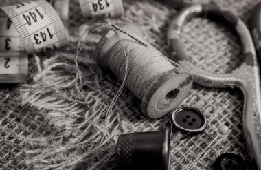Terzi, terzi, moda tasarımcısı işi için geçmişe dönük aletler. İplik, makas, yüksük, düğme ve santimetre ile iğne.