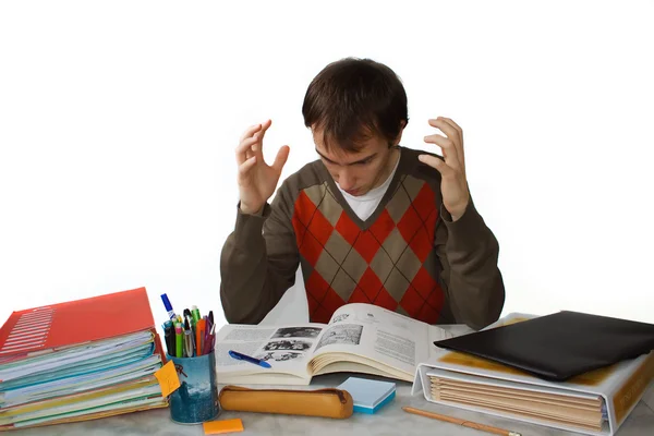 Manlig student vid ett bord, frustrerad — Stockfoto
