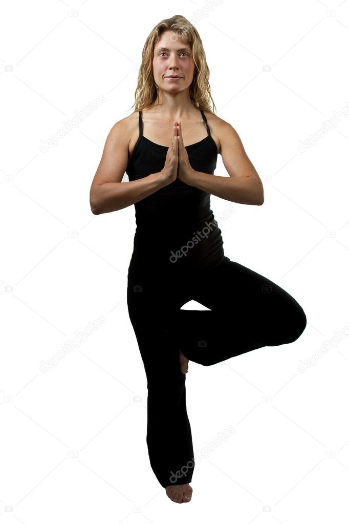 Yoga tree pose, blond woman standing on one foot, hands joined