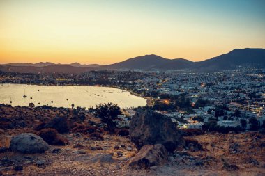 Panoramic view of Gumbet District of Bodrum, mediterranean city in Turkey on aegean coast in sunset. Toned image.