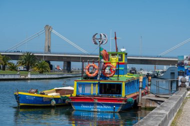 Aveiro, Portugal. 2022 May 12 . Traditional boats in the canal of Aveiro, Portugal. The colorful Moliceiro de Aveiro boat tours are popular with tourists to enjoy views of the charming canals. Aveiro, Portugal.