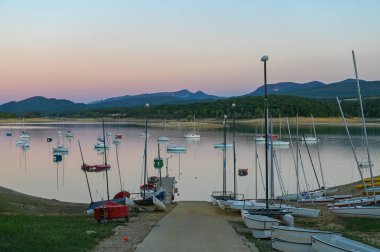 Montbel, France. 2022 August 2 . Sunset on Lake Montbel in Ariege with the boats in the summer of 2022.