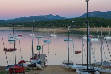 Montbel, France. 2022 August 2 . Sunset on Lake Montbel in Ariege with the boats in the summer of 2022.