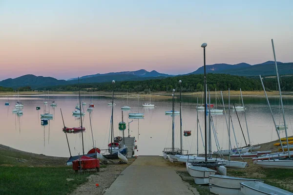 Montbel, France. 2022 August 2 . Sunset on Lake Montbel in Ariege with the boats in the summer of 2022.