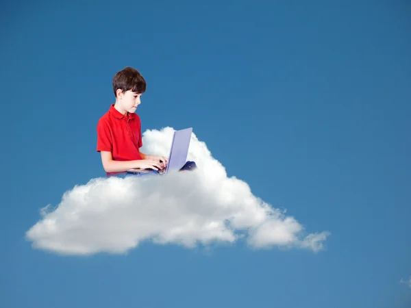 The boy is working with his computer on the cloud — Stock Photo, Image