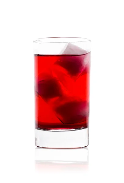 Glass with red liquid and ice — Stock Photo, Image