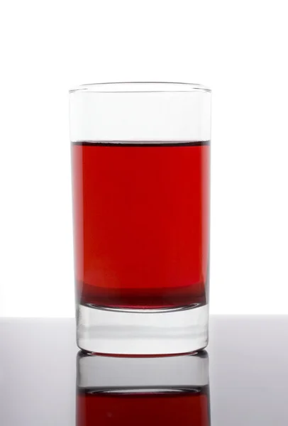 Vetro con liquido rosso — Foto Stock