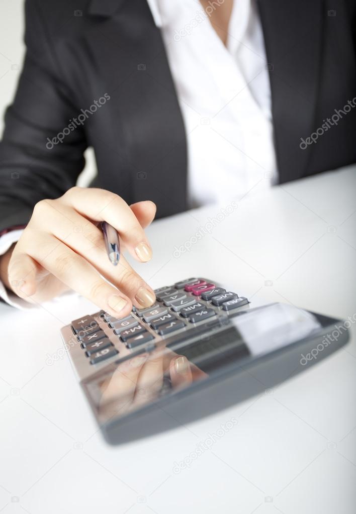 Woman fingers are on the calculator keys