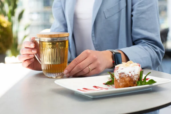 Girl enjoing homemade Traditional Austrian strudel with cherry or red berries and powdered sugar with cup of tea. Menu for cafe. Bright background.
