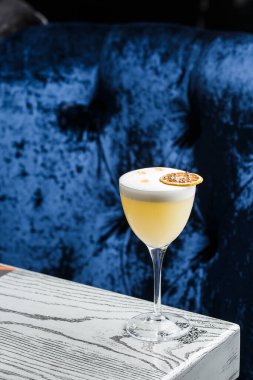 Sarı limon kokteyli ile süslenmiş cam ananas ve nane ile bulanık tezgah arka planında.