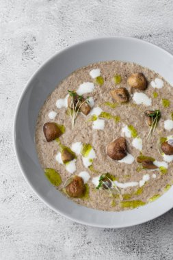 Gri mermer arka planda kızarmış şampiyonlarla bir kase mantar kremalı çorba. Kış, sonbahar sıcak çorba konsepti.