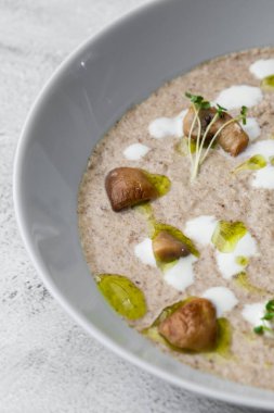 Gri mermer arka planda kızarmış şampiyonlarla bir kase mantar kremalı çorba. Kış, sonbahar sıcak çorba konsepti.