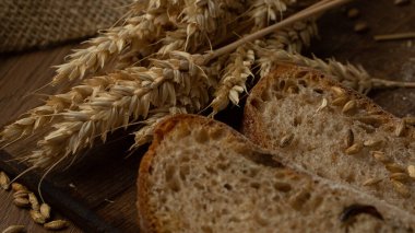 Ev yapımı ekmeğin yakın çekimi. Köylü somun ekmeği ve buğday filizi, yazı için yer var. Ev yapımı pişirme. Gri ekmek tahtada