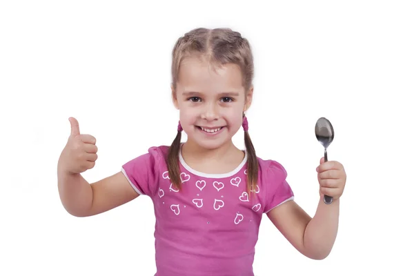 用勺子微笑的小女孩 免版税图库图片