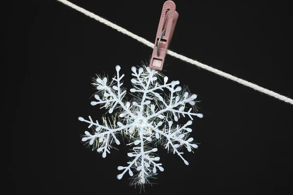Snowflake on a clothespeg — Stock Photo, Image