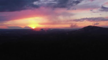 Doğal manzaranın havadan görünüşü. Güneşin dağların üzerinden batışı.