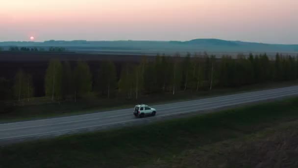 Vista aérea del coche que conduce en la carretera contra el fondo del bosque — Vídeos de Stock