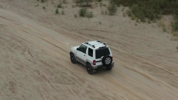 Vista aérea de um carro dirigindo na areia — Vídeo de Stock