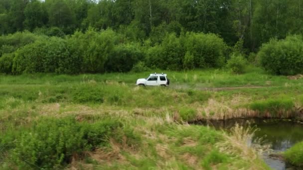 Aerial view of a car driving in nature near the river — 图库视频影像