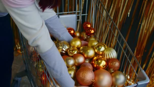 Side View Crop Anonymous Female Choosing Golden Decorative Baubles Trolley — Stock Video