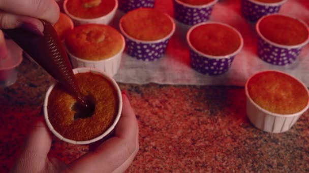 Pequenos Cupcakes Mesa Mulher Irreconhecível Enche Engarrafamento Cupcake Close Mãos — Vídeo de Stock