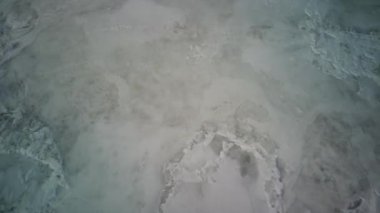 Kış mevsiminde buz dokusunun havadan görünüşü. Donmuş nehrin kuş bakışı görüntüsü. Buz gibi karlı nehir.