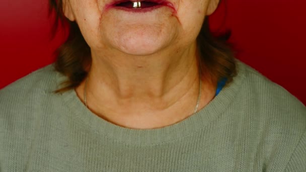 Part Elderly Woman Face Red Background Unrecognizable Mature Woman Smiling — стоковое видео