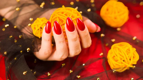 Anonymous Female Red Manicure Decorative Wicker Balls Red Background — Stock Photo, Image