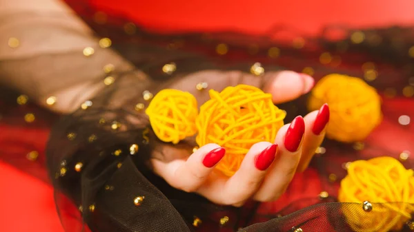 Anonymous Female Red Manicure Decorative Wicker Balls Red Background — Stock Photo, Image