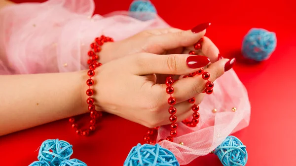 Crop Anonymous Woman Red Beads Red Manicure Red Background Studio — Stock Photo, Image