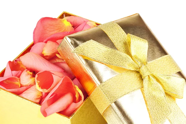 Golden box full of roses petals Royalty Free Stock Photos