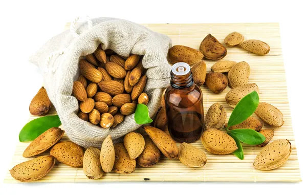 Almonds in the sack and almond oil — Stock Photo, Image