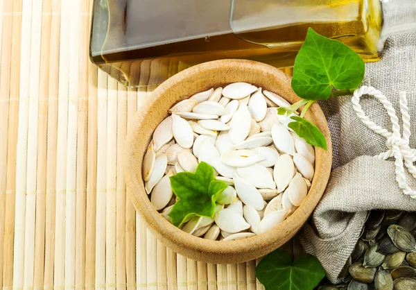 Composition from pumpkin seeds and pumpkin oil — Stock Photo, Image