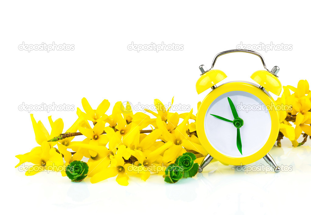 Spring yellow concept with clock and flowers